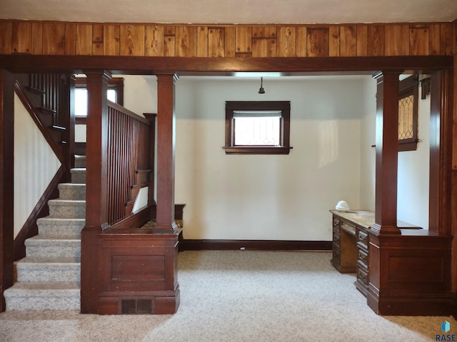 interior space with ornate columns and carpet flooring