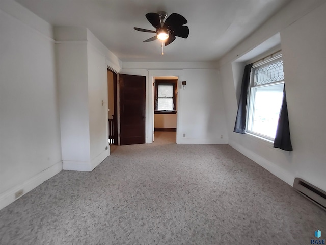 empty room with ceiling fan and baseboard heating