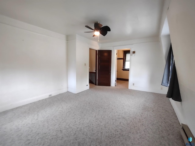 unfurnished room with a baseboard heating unit and ceiling fan