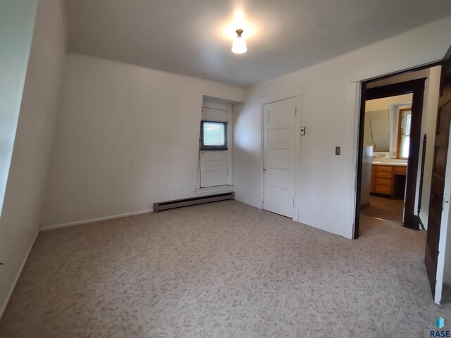 unfurnished bedroom with a baseboard radiator