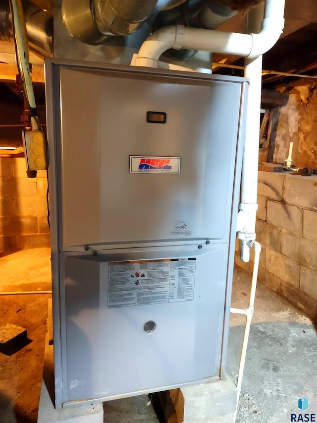 utility room featuring heating unit