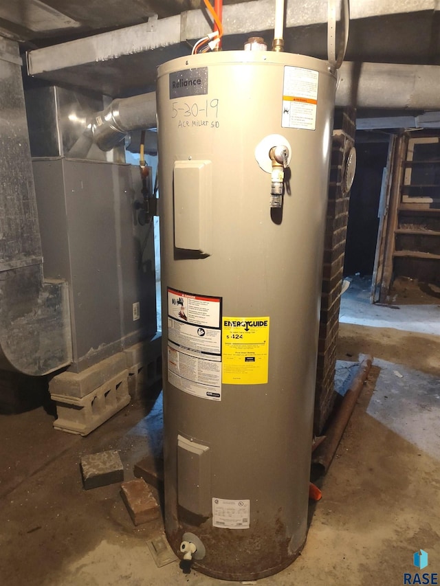 utility room with electric water heater and heating unit