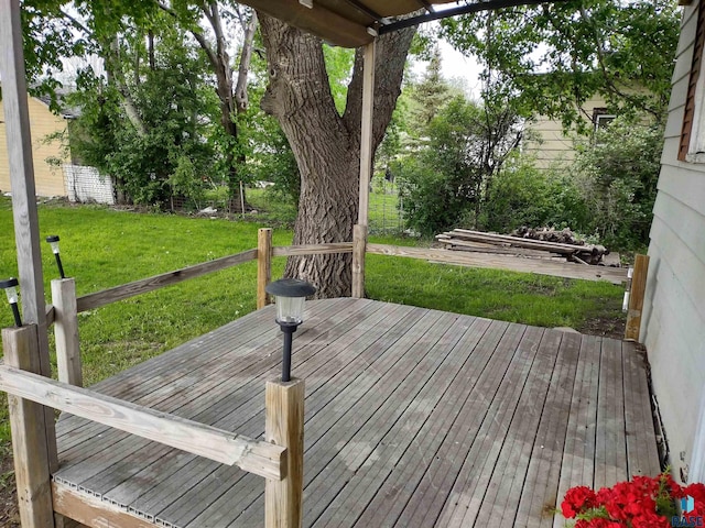 wooden terrace with a lawn