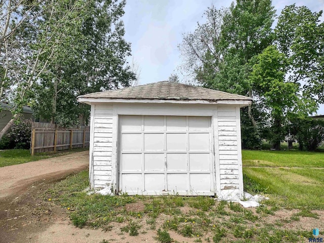 garage featuring a lawn