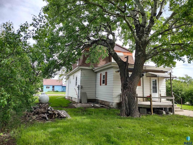 back of house with a lawn