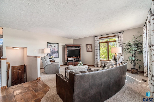 living room featuring carpet flooring and a textured ceiling