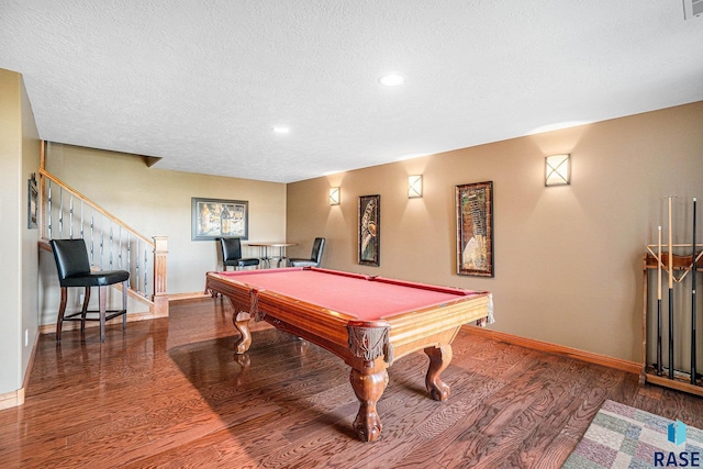 recreation room featuring dark wood-type flooring, pool table, and a textured ceiling