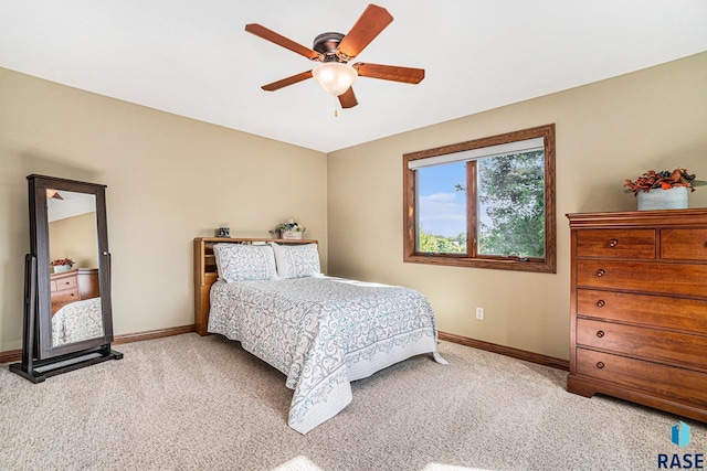 bedroom featuring ceiling fan and light carpet