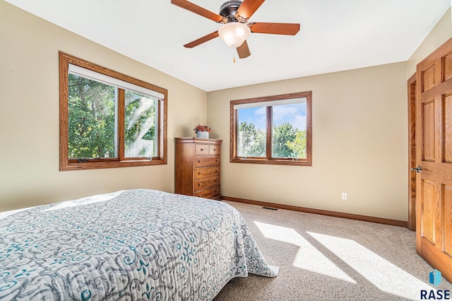 bedroom featuring multiple windows, carpet floors, and ceiling fan