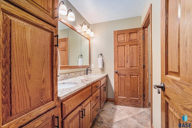 bathroom with vanity and a textured ceiling