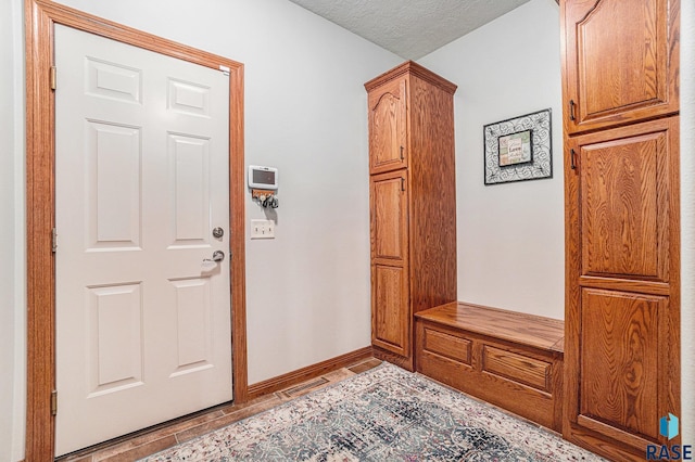 mudroom featuring a textured ceiling