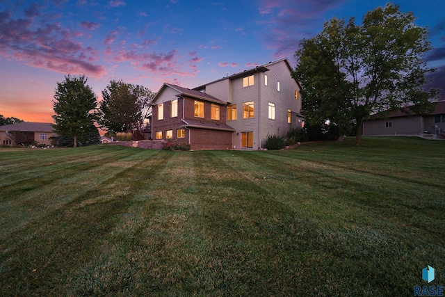 rear view of property with a yard