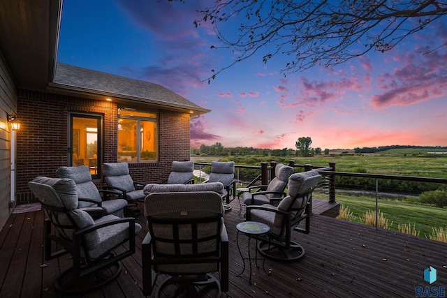 deck at dusk featuring an outdoor hangout area