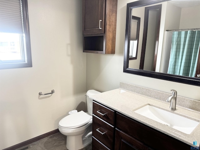 bathroom featuring vanity, toilet, and a shower with shower curtain