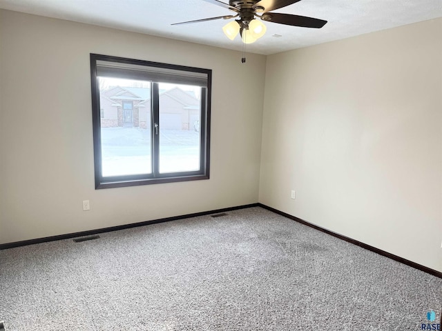 spare room featuring carpet floors and ceiling fan