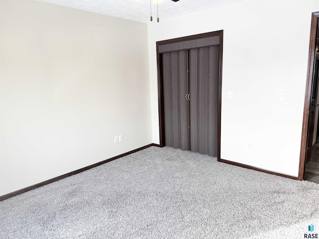 unfurnished room with ceiling fan and carpet floors