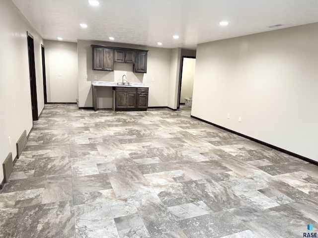 kitchen featuring sink and dark brown cabinets