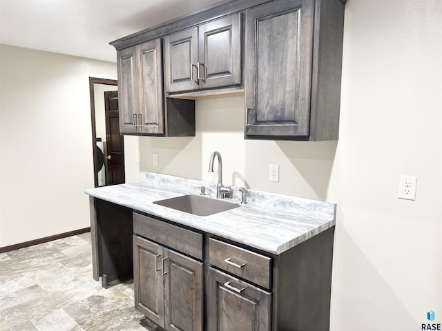 kitchen featuring dark brown cabinetry and sink