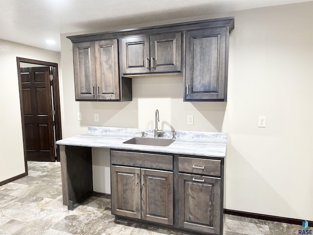 kitchen featuring sink and dark brown cabinets