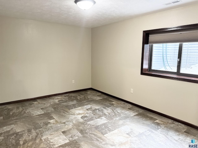 spare room featuring a textured ceiling