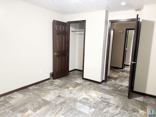 unfurnished bedroom with a textured ceiling