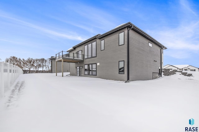 view of snow covered rear of property