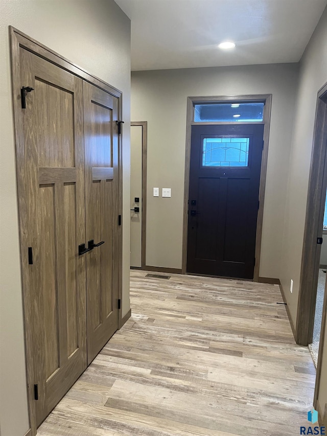 foyer entrance with light wood-type flooring