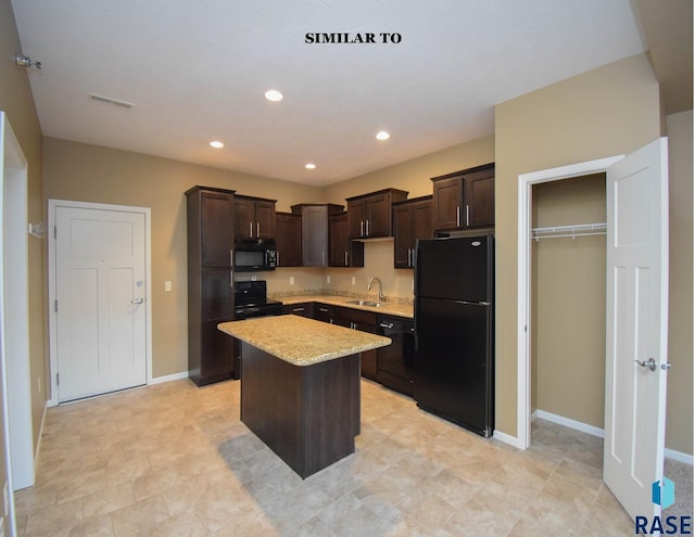 kitchen featuring dark brown cabinetry, a center island, sink, and black appliances