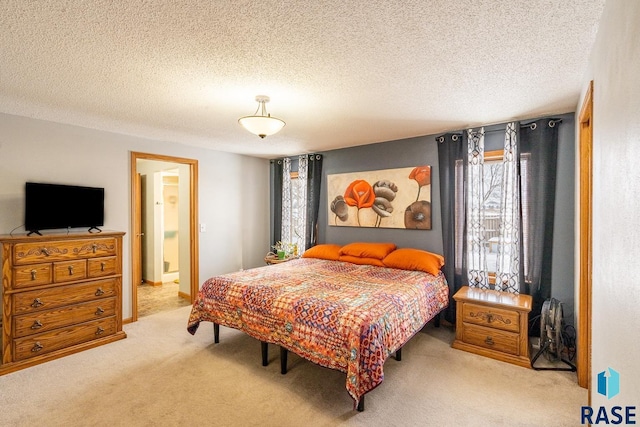 bedroom with light carpet and a textured ceiling