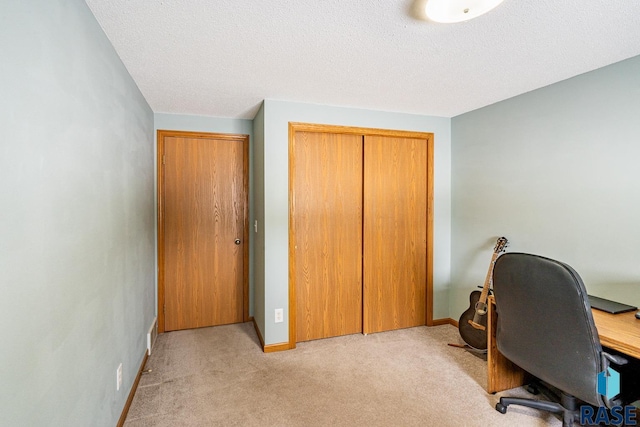 office space with light colored carpet and a textured ceiling