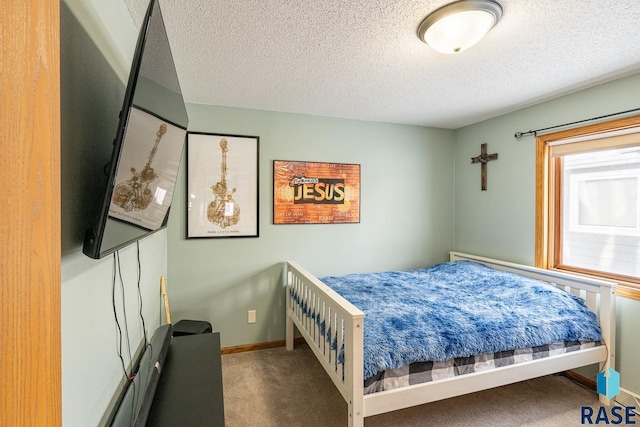 carpeted bedroom featuring a textured ceiling