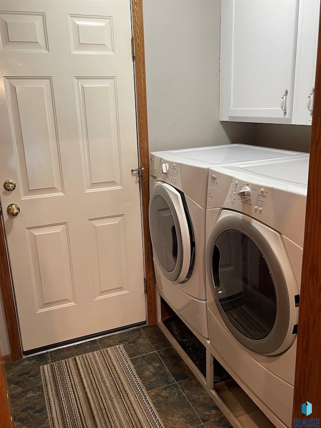 laundry area with washing machine and dryer and cabinets