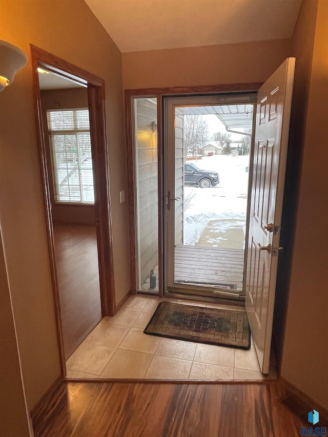 entryway featuring vaulted ceiling and light hardwood / wood-style floors