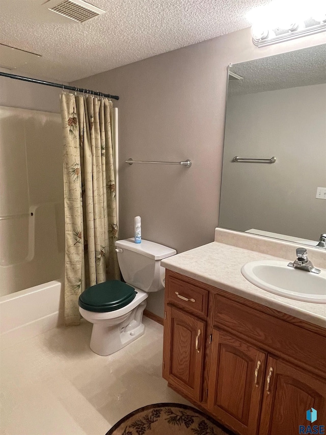 full bathroom featuring shower / bath combination with curtain, vanity, toilet, and a textured ceiling