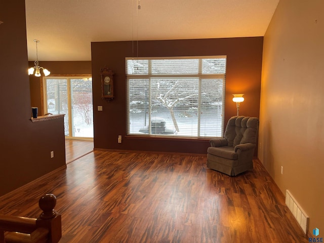 unfurnished room featuring dark wood-type flooring and a chandelier