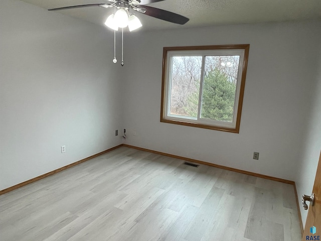 unfurnished room with ceiling fan and light hardwood / wood-style floors