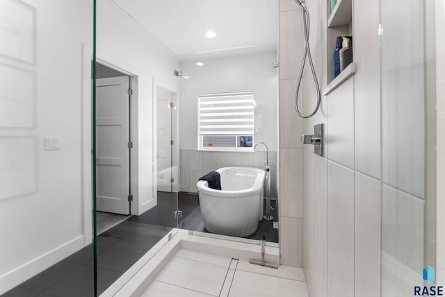 bathroom featuring tile walls, tile patterned flooring, and shower with separate bathtub