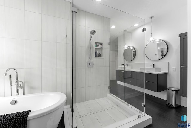 bathroom with vanity, hardwood / wood-style floors, and independent shower and bath