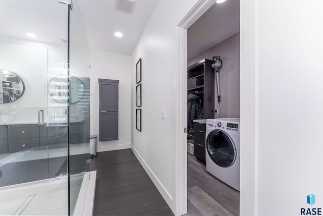 washroom featuring dark hardwood / wood-style flooring and washer / dryer