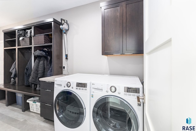 laundry area featuring cabinets and washer and clothes dryer