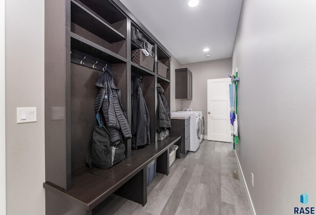 mudroom with light hardwood / wood-style flooring and washer and clothes dryer