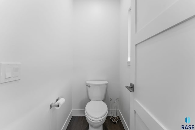 bathroom featuring wood-type flooring and toilet