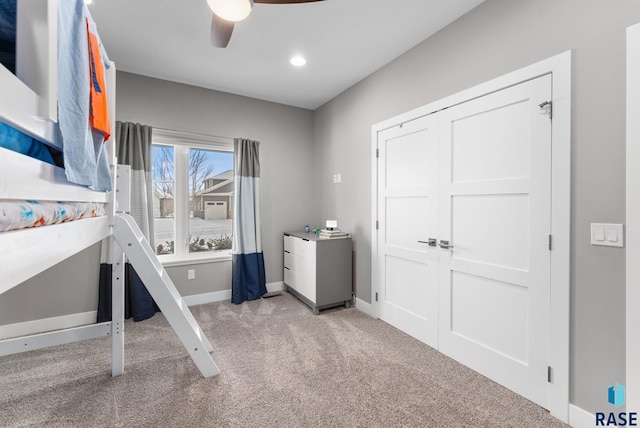 unfurnished bedroom with ceiling fan and light colored carpet