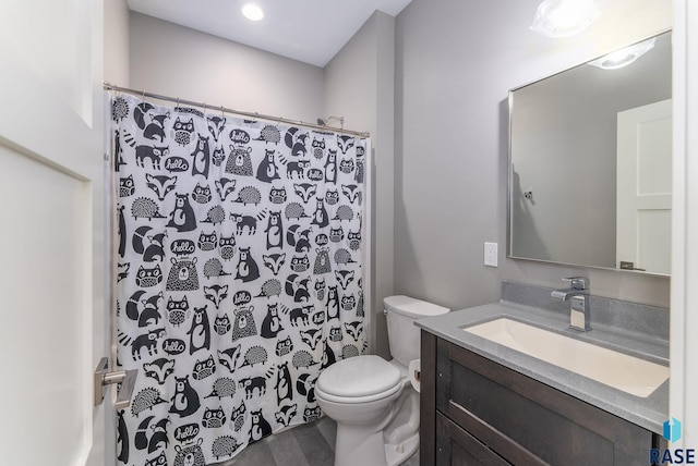 bathroom featuring vanity, a shower with curtain, and toilet