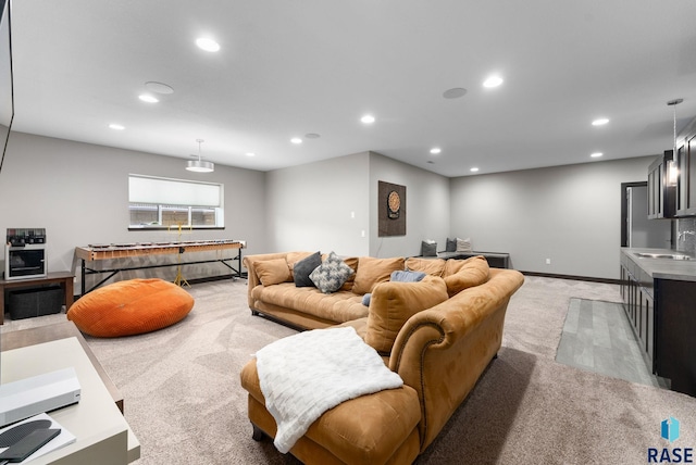 carpeted living room with sink