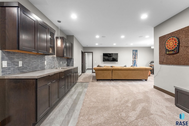 carpeted living room with sink