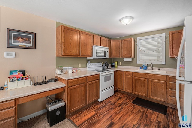 kitchen with white appliances, dark hardwood / wood-style floors, and sink