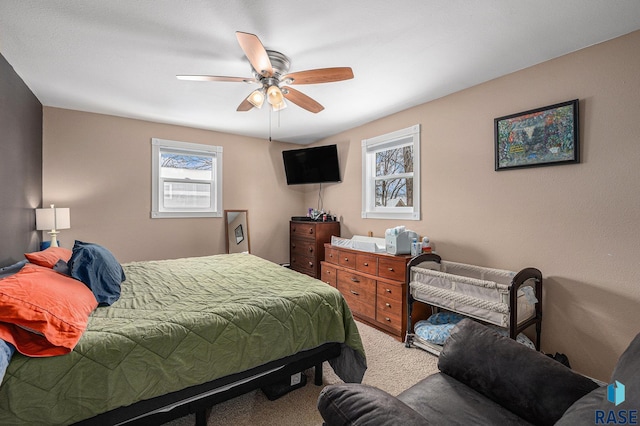 carpeted bedroom with ceiling fan