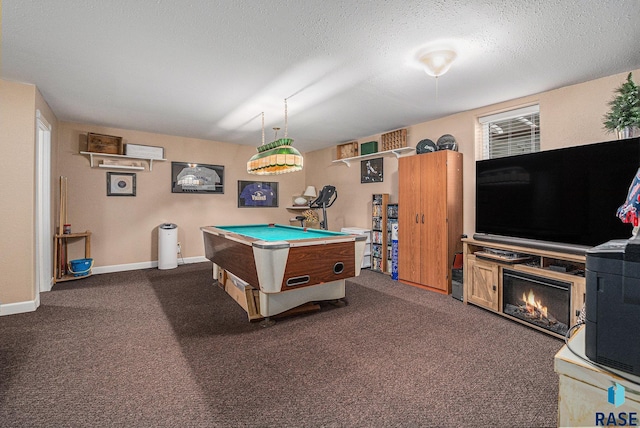 game room featuring dark carpet, pool table, and a textured ceiling