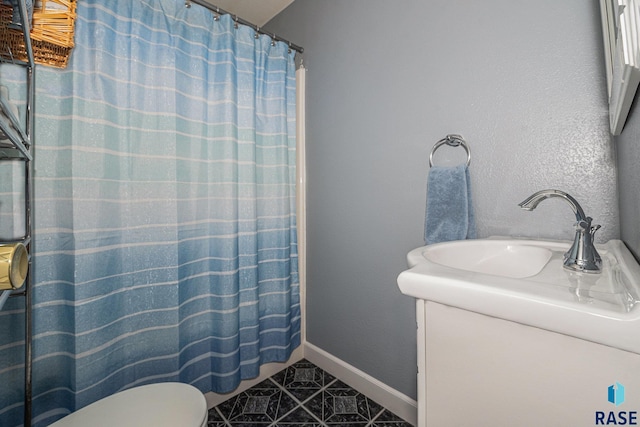 bathroom with vanity, a shower with shower curtain, tile patterned floors, and toilet